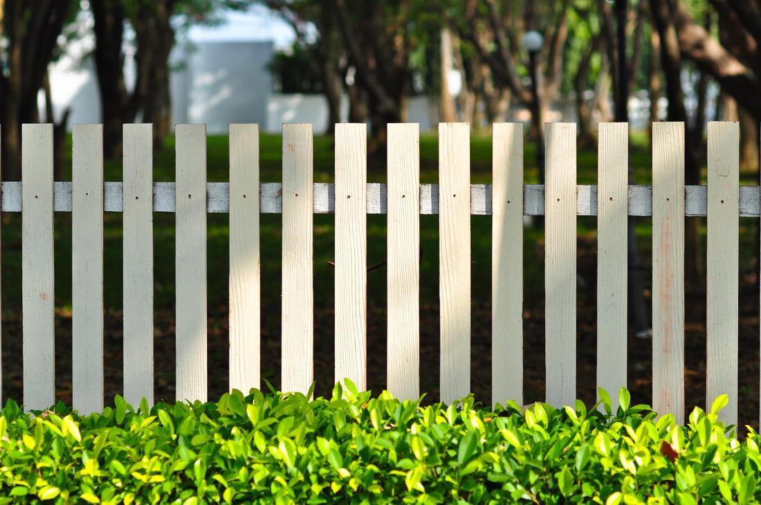 a park with vinyl fence